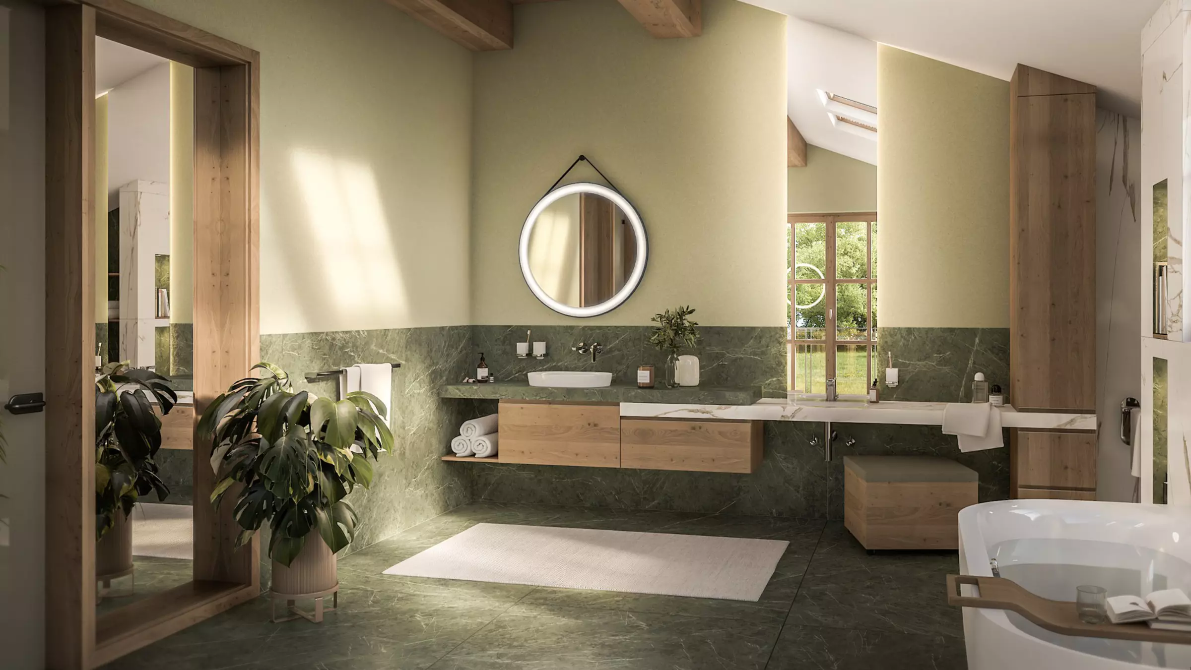 Bathroom in shades of green with wooden furniture, round mirror and washbasin.
